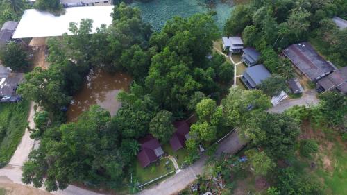 an aerial view of a house with trees and water at Snapper House in Khao Lak