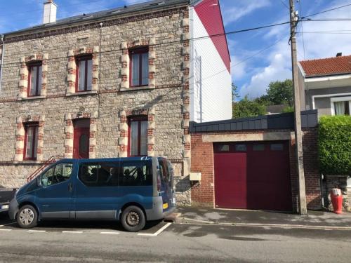 a blue van parked in front of a brick building at Entre Meuse et forêt in Revin