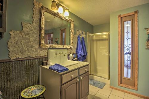 a bathroom with a sink and a mirror at Lakefront Deer River Apt with Dock, Fire Pit and Patio in Deer River