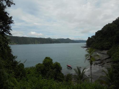 a boat in the middle of a body of water at Hotel Nuquimar in Nuquí