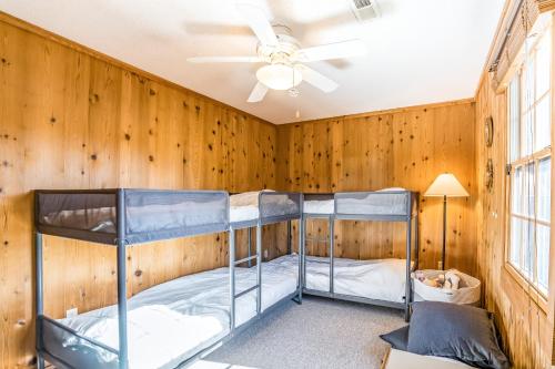two bunk beds in a room with wooden walls at Tinker's Toy 233 in Waves