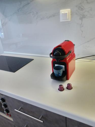 a red toaster sitting on top of a counter at Eternal Suites Edessa in Edessa