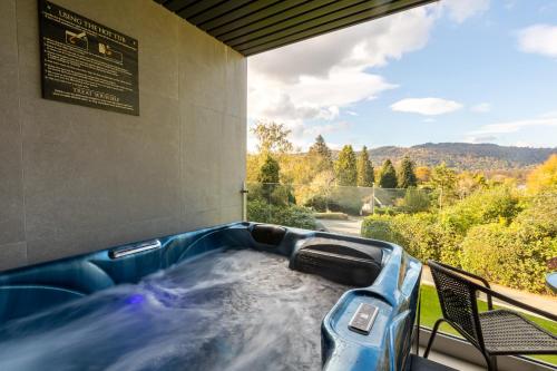 a jacuzzi tub with a view of the mountains at Lakes Hotel & Spa in Bowness-on-Windermere