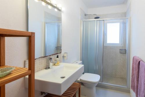 a bathroom with a sink and a toilet and a shower at Casa en Ibiza con vistas increíbles en Es Figueral in Es Figueral Beach