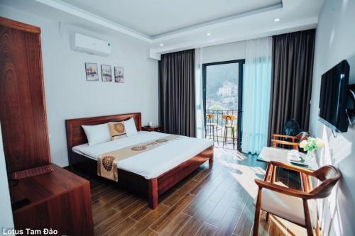 a hotel room with a bed and a balcony at Lotus Tam Đảo Hotel in Tam Ðảo