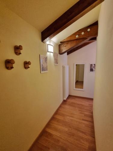 a room with a hallway with teddy bears on the wall at Saluzzo Historic Center Apartment in Saluzzo