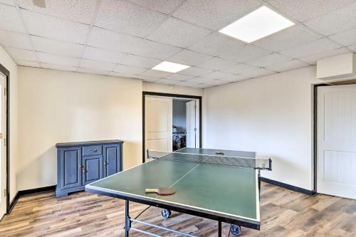 an empty room with a ping pong table in it at Deck and Game Room Blue Ridge Mountain Cabin! in Warne