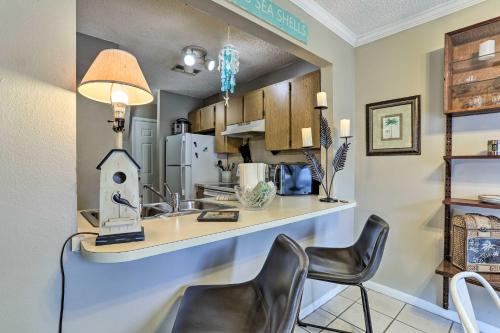 a kitchen with two chairs and a counter with a sink at Seminole Townhome Easy Access to Beaches! in Seminole