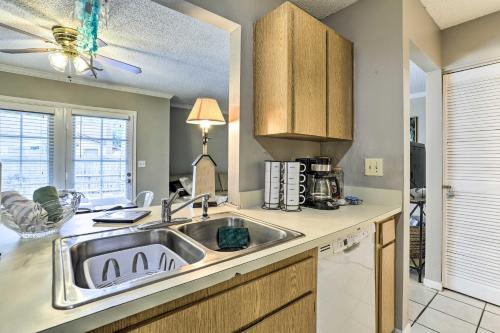 a kitchen with a stainless steel sink and cabinets at Seminole Townhome Easy Access to Beaches! in Seminole