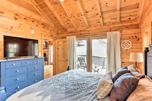 a bedroom with a bed with a blue dresser and a television at Deck and Game Room Blue Ridge Mountain Cabin! in Warne