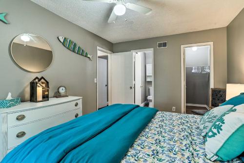 a bedroom with a blue bed and a mirror at Seminole Townhome Easy Access to Beaches! in Seminole