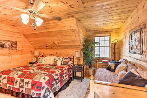 a log cabin bedroom with a bed and a couch at Deck and Game Room Blue Ridge Mountain Cabin! in Warne