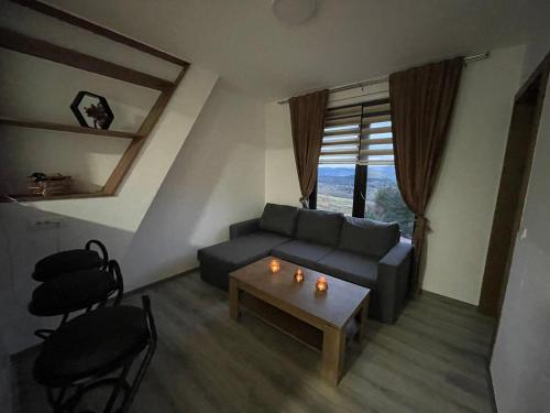 a living room with a couch and a table at Planinska Kraljica in Gornje Pale