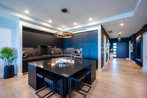 a kitchen with blue cabinets and a large island at Black Urchin Boutique Resort in Belford Estates