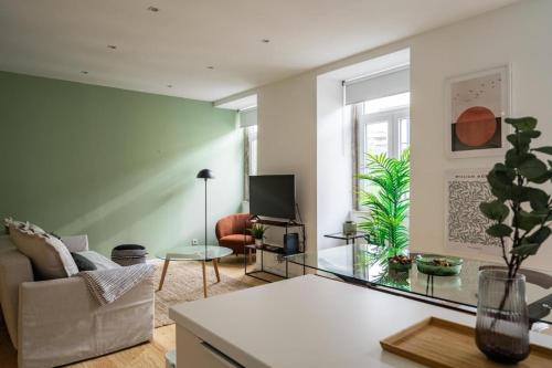 a living room with a couch and a table at WHome Chic 2-Bed near Santos & Alcântara perfect for Families & Couples in Lisbon