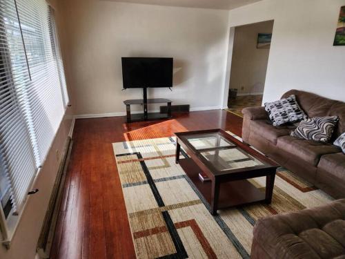 a living room with a couch and a coffee table at Spacious 4-bedroom home in quiet neighborhood in Milwaukee