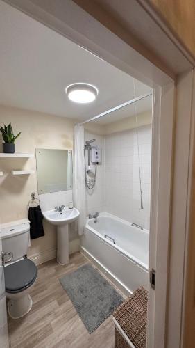 a bathroom with a tub and a sink and a toilet at Central London spacious Studio in London