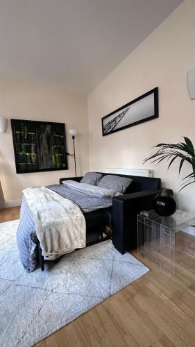 a bedroom with a bed with a desk and a rug at Central London spacious Studio in London