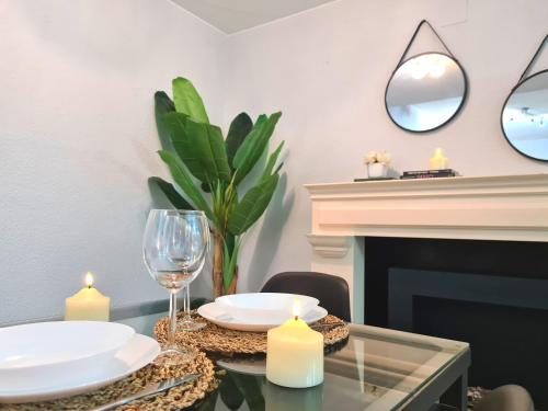 a dining room with a table with candles and a fireplace at Dos Torres Bárbol - Jacuzzi en la Habitación y Garaje en el Centro in Zaragoza