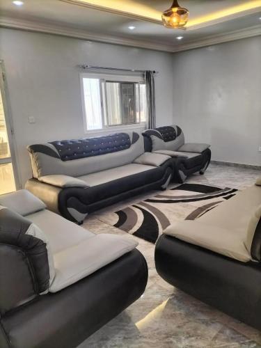 a room with a bunch of couches in a room at Maison d'Hôtes entière Cité Douane Golf Dakar in Dakar