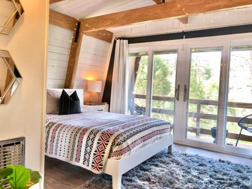 um quarto com uma cama e uma janela em Maison Solange-Red Barn Farmhouse Style- Moonridge em Big Bear Lake