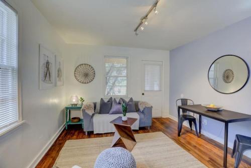 a living room with a couch and a table at Midtown Cottage Walk to Overton Square in Memphis