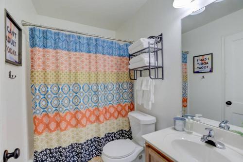 a bathroom with a toilet and a sink at Midtown Cottage Walk to Overton Square in Memphis