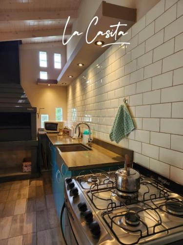 a kitchen with a stove top oven in a kitchen at La Casita in Junín de los Andes