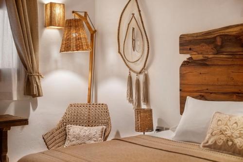 a bedroom with a bed with a mirror and a lamp at El Corazón Boutique Hotel - Adults Only with Beach Club pass included in Holbox Island