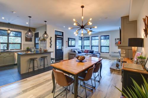 a kitchen and living room with a wooden table and chairs at Rental condo Tremblant-les-Eaux in Mont-Tremblant