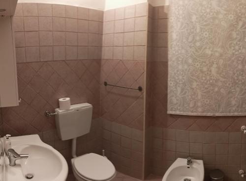 a bathroom with a toilet and a sink at Saint Mary Magdalene in Acqui Terme