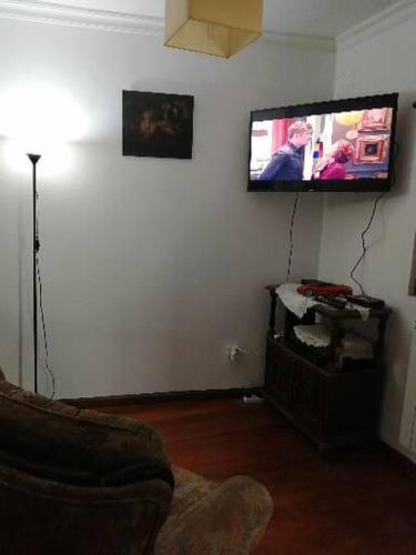 a living room with a couch and a flat screen tv at Casa Véronique in Soajo