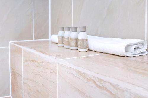 a white counter with three bottles on it in a bathroom at Lovely 2 - bedroom London Bridge apartment in London