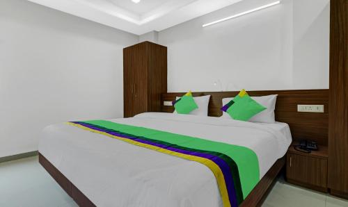 a bedroom with a bed with a rainbow on it at Treebo Raga in Visakhapatnam