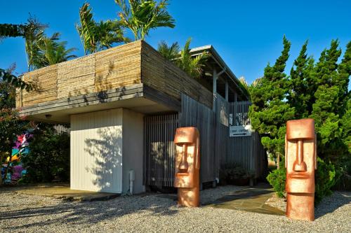 a building with two rusted objects in front of it at The Montauk Beach House in Montauk