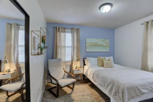 a bedroom with blue walls and a bed and chairs at Gated Retreat Steps from Midtown's Best Parking in Memphis