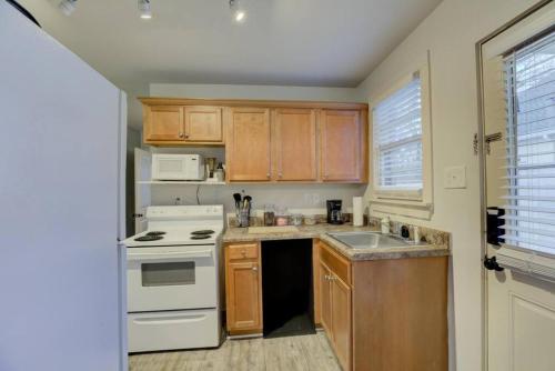 a kitchen with a white stove and a sink at Gated Retreat Steps from Midtown's Best Parking in Memphis