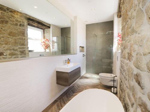 a bathroom with a sink and a toilet and a shower at Laburnum Cottage in Alnwick