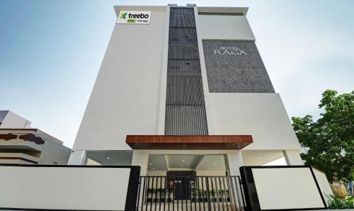 a building with a tower with a sign on it at Treebo Trend Raga in Visakhapatnam