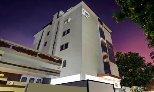 a tall white building with a sign on it at Treebo Raga in Visakhapatnam