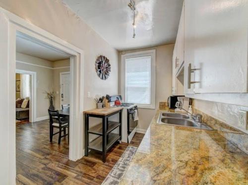 a kitchen with a sink and a counter top at Perfect Location Walking Distance to Everything in Sacramento
