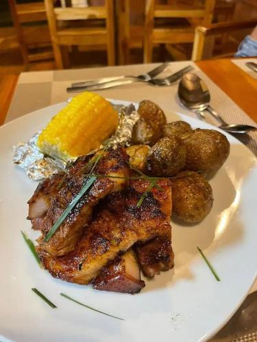 a plate of food with meat and potatoes on a table at Gatun Lake Lodge Hotel in Pueblo Nuevo