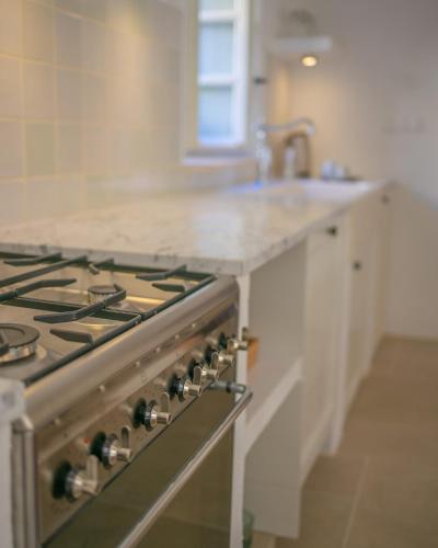 a stove top oven in a kitchen with a sink at Revelin Hvar in Stari Grad