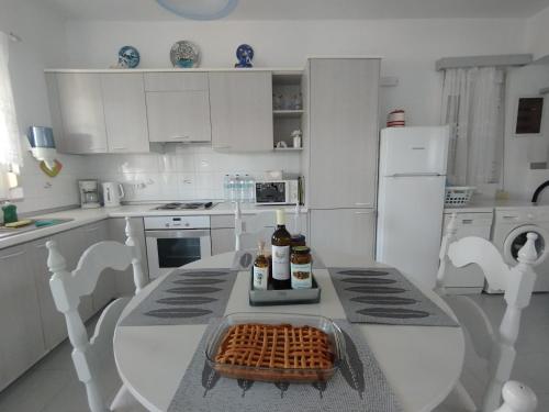 a white kitchen with a table with waffles on it at Aphrodite Villa Gennadi in Gennadi