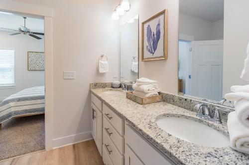 a bathroom with a sink and a large mirror at Serenity Salty Intentions At 14334 Gardenglen Drive in Pensacola
