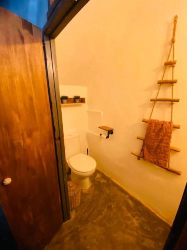 a bathroom with a toilet and a towel on the wall at Casa Cercana in Abarán