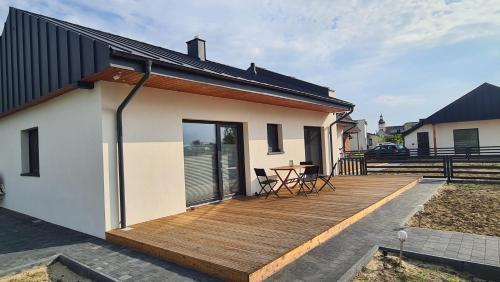 a wooden deck on the side of a house at Wake domek Green House Januszkowice in Januszkowice