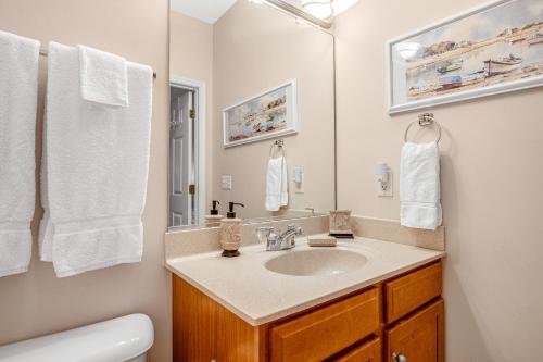 a bathroom with a sink and a mirror at Bear Trap Dunes - 60E October Glory in Ocean View