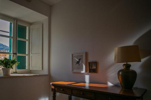 a room with a table with a lamp and a window at Revelin Hvar in Stari Grad