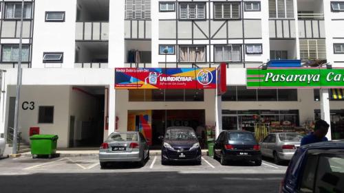 um parque de estacionamento com carros estacionados em frente a um edifício em FE Homestay Cameron Jaya@Tanah Rata em Tanah Rata